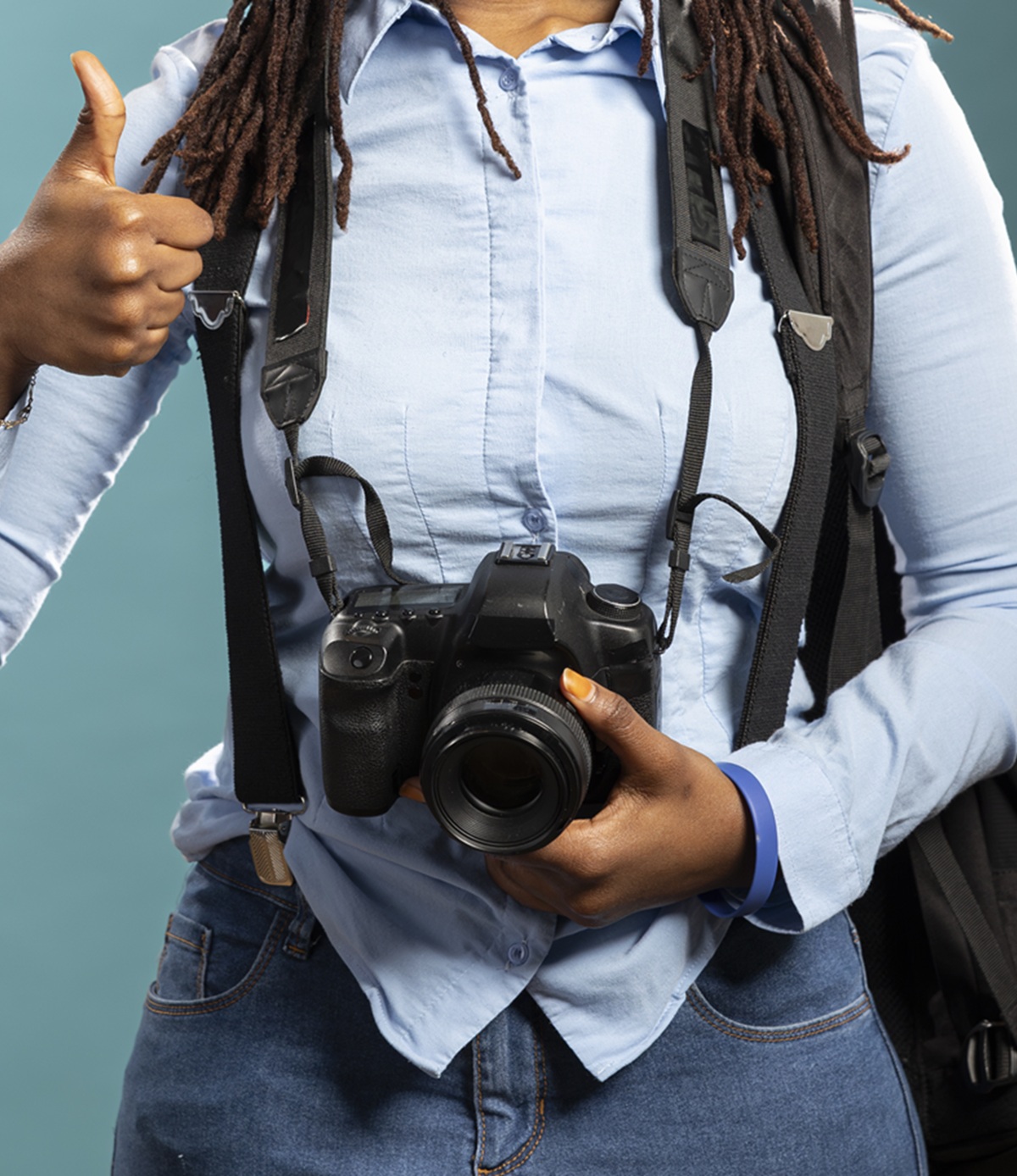 female photographer happily gives thumbs up